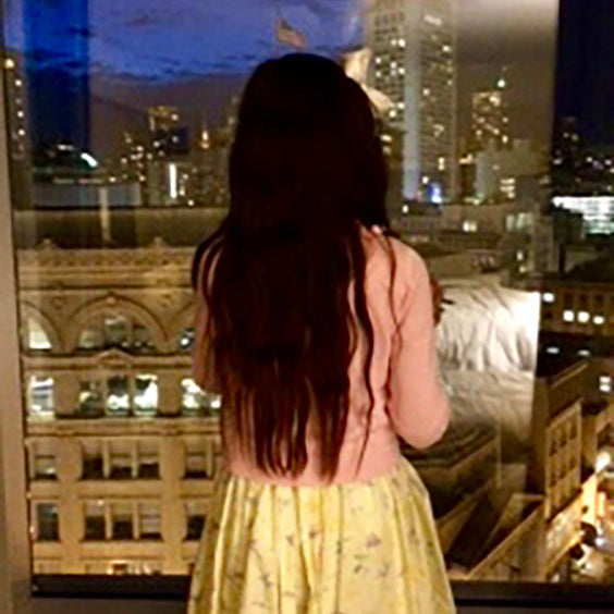 Classic Girl looking out a hotel window 