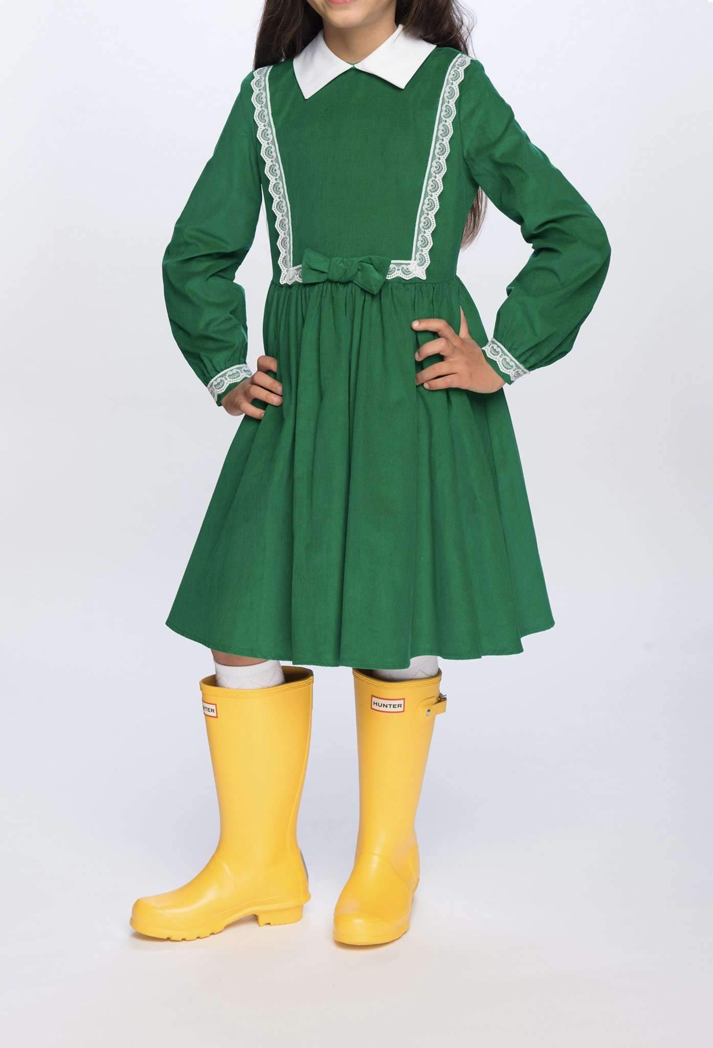 Girl modeling Payton Dress in Green with Yellow Boots